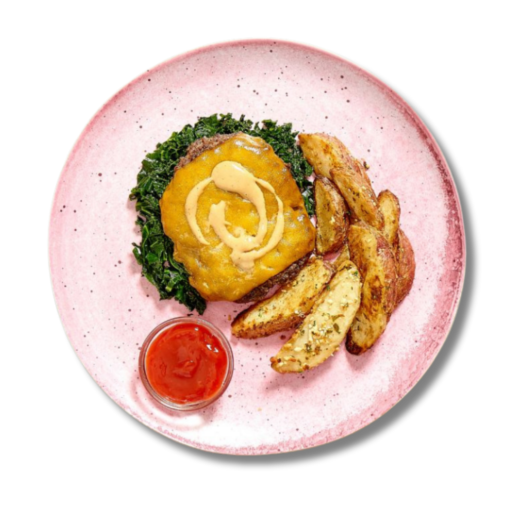 Grill House Burger, a new menu item from Fitlife Foods' summer menu, featuring a beef burger topped with cheddar cheese, kale, and secret sauce, with potato wedges on the side