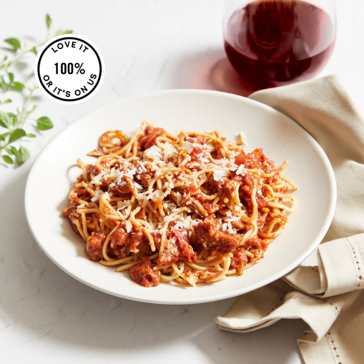 A plate showing Seasoned ground turkey, tomatoes, spices, and ground flaxseeds create a rich bolognese served over protein pasta.
